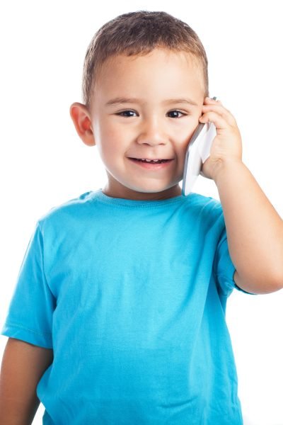 child calling by mobile with a white background child calling by mobile with a white background